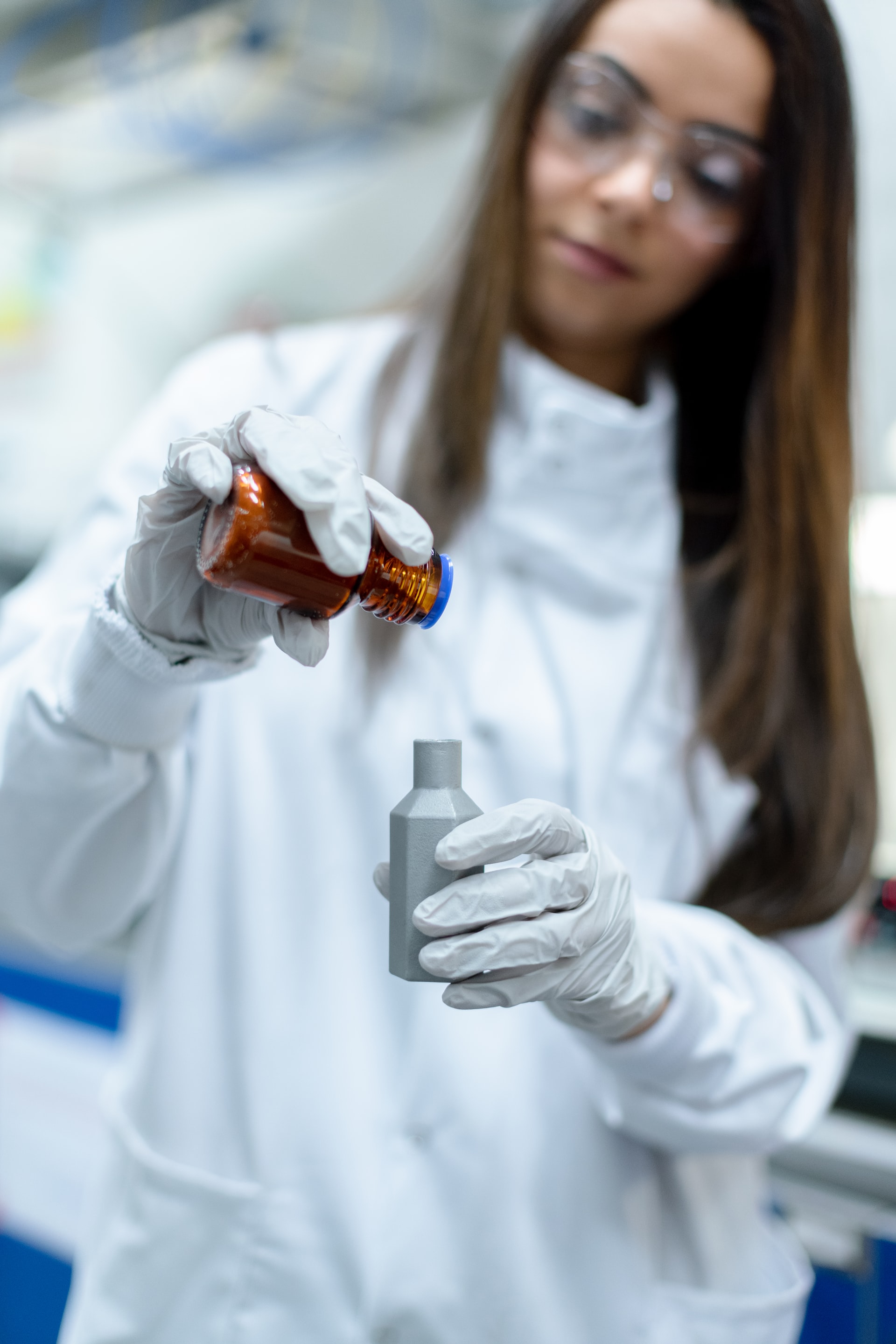 researcher filling cylinder with liquid