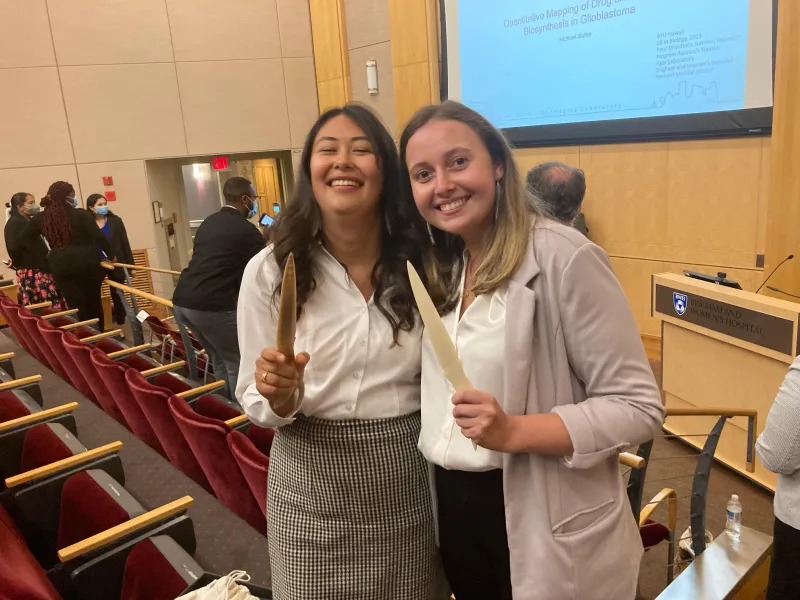 two interns of the Harris lab pose with their bone knives.