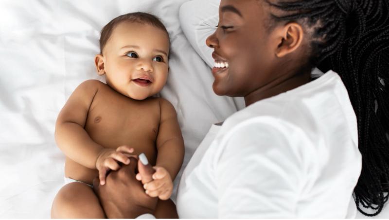 Woman lying next to a baby