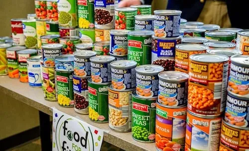 Cans of non-perishable food stacked on a table