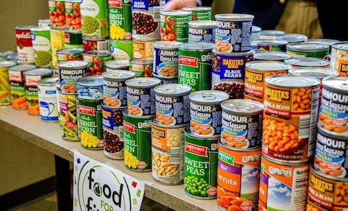 Cans of non-perishable food stacked on a table
