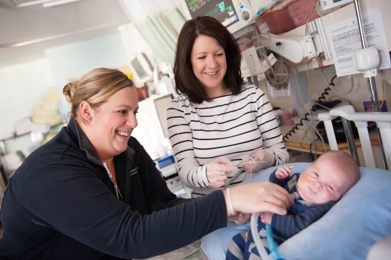 Two women with a baby in the intensive care unit