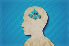 A picture of a human head silhouette with puzzle pieces, a symbol for autism advocacy. 