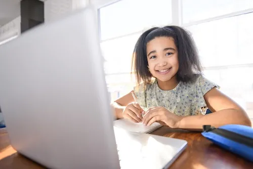 An adolescent girl using a laptop