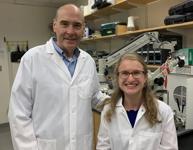 Two researchers posing in a laboratory featured in a study identifying a brainwave biomarker of fragile X syndrome.