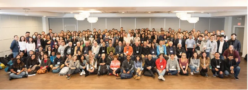 About 100 men and women in a conference room