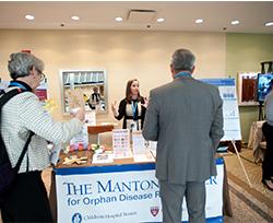 A group gathers at the manton center table at an exhibition hall. 
