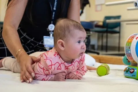 An infant lying on her stomach