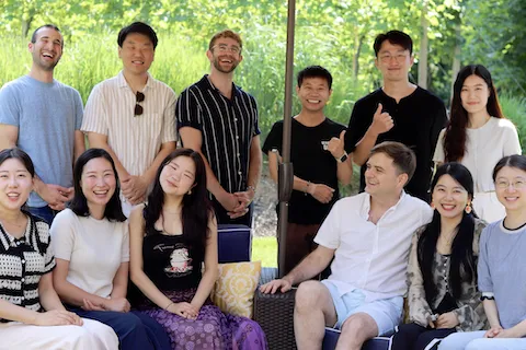 Six men and six women sitting outside